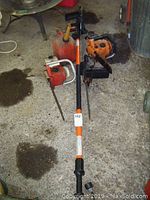Overview photo of all chainsaws and red fuel can spread out on concrete floor, showing overall condition and included items.