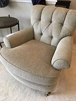 Front three-quarter view showing tufted back, rolled arms and seat cushion