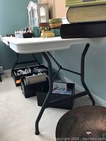 Side angle showing folding table legs and items on top