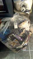 Large clear bag filled with assorted ladies bras, underwear, hosiery and other intimate apparel.