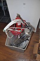 Top view of bin with 2 fire extinguishers and multiple rolls of wiring.
