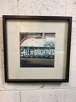 Framed photograph showing the entire piece in black frame with white mat and image centered.