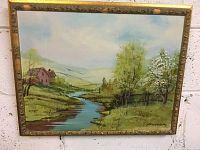Full view of the framed landscape painting with signed artwork and river scene