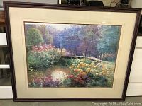 Full view of framed landscape print showing garden scene with bridge, pond, and flowers.
