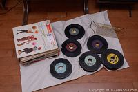 Overview of vinyl singles (45 RPM) laid out showing various labels and condition.
