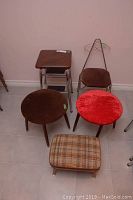 Five items: three stools (two round velvet upholstered in brown and red, one rectangular plaid upholstered), one wooden step stool with metal legs, and one vintage chair with brown velvet seat and metal frame.