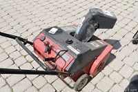 Side and top views of MTD 3HP 21 inch snowblower showing red and black color, controls, wheels, and discharge chute.