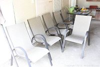 Front angled view showing all six chairs in a row, highlighting mesh seating and metal frames.