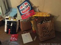 Group of several vintage paper and plastic shopping/garment bags with printed logos and brand names including Painter's Pants, Big Brown Bag.