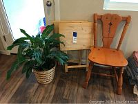 Wooden chair, two wooden TV trays, and potted Spathiphyllum plant together showing the full set.