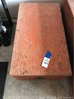 Top view of a rectangular wooden cruise box showing wood grain and surface wear.