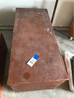 Top view of the wooden rectangular cruise box showing its worn surface and a visible circular stain.