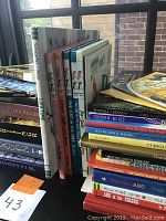 Side view of stacked kids books showing spines with visible titles including Dr. Seuss and fantasy books.