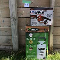 Photo of Performance Tool 600W shop blower box on top of Flo Master 2 gallon sprayer box against wooden background.