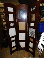 Front view of the three-panel wooden photo screen displaying photo frame inserts with black and white photographs.