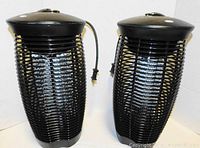 Front view of two black Stinger bug zappers side by side showing overall condition and power cords.