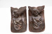 Front view of both mermaid bookends side by side showing sculpted details and overall condition.