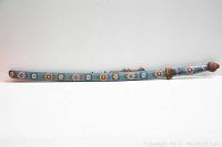 Full-length view of enamel-decorated scabbard on white background