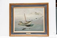 Full view of framed oil painting showing boat in icy landscape with snow-covered islands and original frame.