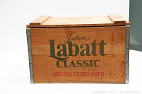 Front side of wooden crate labeled John Labatt Classic Special Extra Aged with hinged lid on top