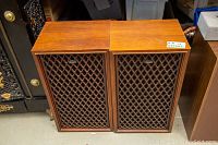 Pair of Coral wooden cabinet speakers with lattice front grills and Coral badges visible