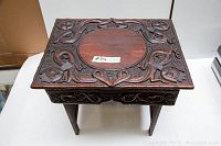 Top view showing central round inset panel and surrounding carved scroll and foliate motifs
