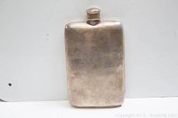 Front view of the rectangular sterling silver hip flask with screw-top cap
