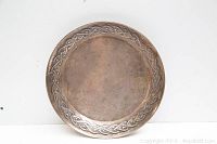 Full front view of round plate showing Celtic knot border