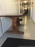 Front angled view of table showing trestle base and tabletop