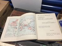 Opened volume of Cassell's History of England showing map of British Empire and title page for Volume II.