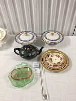 Two Limoges porcelain serving dishes with lids, displayed side by side on table