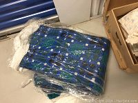 Photo of blue Welsh woven blanket wrapped in plastic on floor
