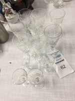 Full view of all twelve crystal glasses including sherry and liquor glasses arranged on table