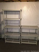 Two stacked and side-by-side plastic shelving units against a white wall in basement, showing their size and structure.