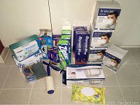 Photo showing multiple boxes of N95 masks, Reynolds Wrap foil, Ziploc bags, and cleaning wipes on a white surface.