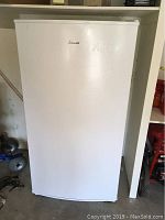 Front exterior view of white Amana upright freezer