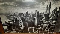 Framed black and white photo of Manhattan skyline showing skyscrapers including Empire State Building