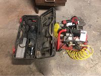 Craftsman reciprocating saw in its case alongside the Craftsman air compressor and nailer/stapler