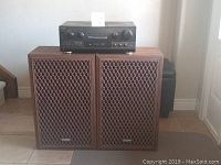 Two Sears GR-10 speakers with wood cabinets and metal grille covers, Technics stereo receiver on top