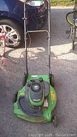 Front view of green Lawnboy lawn mower showing mower deck, engine with pull start, and wheels.