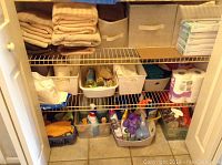 Closet shelves with linens, cleaning supplies, detergent, and household items in bins and containers