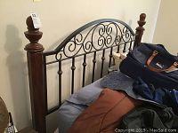 Headboard with wooden posts and metal scrollwork