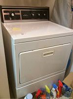 Full view of white Kenmore electric dryer showing front door and control panel.