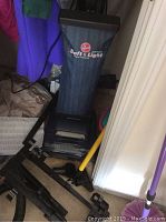 Full view of Hoover upright bag vacuum with fabric bag, attachments, and telescoping pole