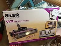 Boxed Shark Cordless VX3 Floor & Carpet Cleaner showing product features and packaging.