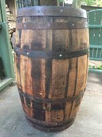 Front view of the oak barrel showing metal hoops and wood staves, top closed.