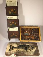 Photo showing the three main items: wooden rack with motel rate cards, shadow box cabin scene, and hand painted fish board.