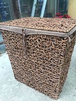 Side and front view of a rectangular laundry basket made with a rope wrapped metal frame, showing the texture and sturdiness.
