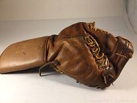 Overall side profile of brown leather goalie catch glove showing scoop and wrist cuff
