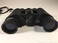 Front view of Kodak T840 binoculars showing the lenses, Kodak and model markings, and center focus knob.